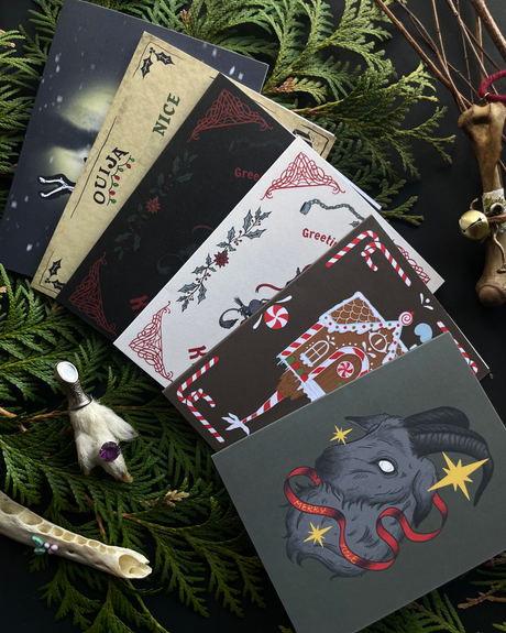 Collection of greeting cards with festive designs on a green leafy background