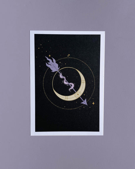 A 5x7 print of a hand-drawn illustration featuring a crescent moon with an arrow, representing the Sagittarius zodiac, set against a dark background with stars and a floral motif.